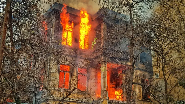 Fire-damaged house with emergency services