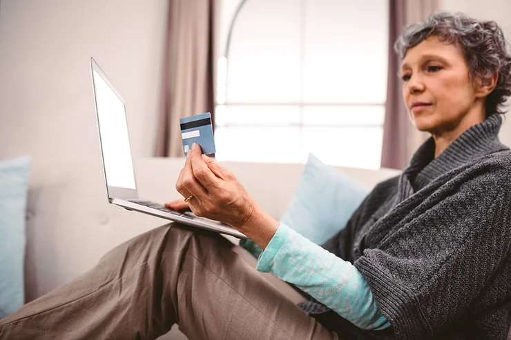 Person making a secure online payment using a laptop, representing digital transactions and safe financial technology.
